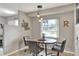 Cozy dining area with a round table, modern lighting, and natural light from the window at 3522 Royal S Ct, Lakeland, FL 33812