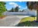 Spacious driveway with a white fence, mature landscaping, and ample parking space at 3522 Royal S Ct, Lakeland, FL 33812