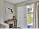 Welcoming entryway with a wooden table, decorative Florida wall art, and neutral décor at 3522 Royal S Ct, Lakeland, FL 33812