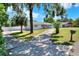 Well-maintained single-story home with a long driveway, green lawn, and mature trees at 3522 Royal S Ct, Lakeland, FL 33812