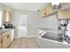 Cozy kitchen featuring tile floors, bright cabinets, and modern appliances for easy meal preparation at 3522 Royal S Ct, Lakeland, FL 33812