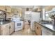 Kitchen features light wood cabinets and a view into a separate dining area at 3522 Royal S Ct, Lakeland, FL 33812