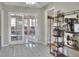 Open kitchen area with ample storage on shelving, tile floors, and access to a playroom with french doors at 3522 Royal S Ct, Lakeland, FL 33812