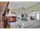 Living room featuring brick fireplace, bar, and sliding glass doors to additional spaces at 3522 Royal S Ct, Lakeland, FL 33812