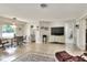 Open-concept living room with tile flooring, dining area, and neutral paint colors at 3522 Royal S Ct, Lakeland, FL 33812