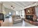 Living room featuring a brick fireplace, vaulted ceilings, and an open floor plan at 3522 Royal S Ct, Lakeland, FL 33812