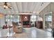 Cozy living room with brick fireplace, bar area, and high ceilings with natural light at 3522 Royal S Ct, Lakeland, FL 33812