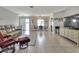 Bright living space featuring tile flooring, a comfortable sofa, and an adjacent dining area at 3522 Royal S Ct, Lakeland, FL 33812