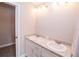 Bright bathroom featuring a dual sink vanity, a stone countertop, and white cabinets at 4042 Old Bartow Eagle Lake Rd, Bartow, FL 33830