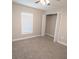 Neutral carpeted bedroom featuring a ceiling fan, a window, and a walk-in closet at 4042 Old Bartow Eagle Lake Rd, Bartow, FL 33830
