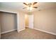 Neutral carpeted bedroom featuring a ceiling fan and an entranceway at 4042 Old Bartow Eagle Lake Rd, Bartow, FL 33830