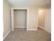 Neutral carpeted bedroom featuring a walk-in closet and an entranceway at 4042 Old Bartow Eagle Lake Rd, Bartow, FL 33830