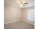 Relaxing bedroom features neutral walls, soft carpet, bright window, and a ceiling fan at 4042 Old Bartow Eagle Lake Rd, Bartow, FL 33830