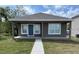 Charming single-story home featuring a covered front porch and a well-maintained lawn at 4042 Old Bartow Eagle Lake Rd, Bartow, FL 33830