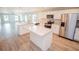 Open kitchen featuring an island, granite countertops, stainless steel appliances, and a view of the living area at 4042 Old Bartow Eagle Lake Rd, Bartow, FL 33830