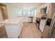 Modern kitchen showcasing white cabinets, stainless steel appliances, and granite countertops at 4042 Old Bartow Eagle Lake Rd, Bartow, FL 33830