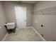 Laundry room featuring tile flooring, utility sink, shelving, and washer/dryer hookups at 4042 Old Bartow Eagle Lake Rd, Bartow, FL 33830