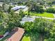 Aerial view showing roof and surroundings, highlighting greenery and proximity to commercial area at 405 S 7Th Ave, Bartow, FL 33830