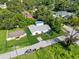 Aerial view of a well-maintained home with a green lawn and mature trees at 405 S 7Th Ave, Bartow, FL 33830