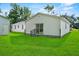 Exterior shot of a home with a large backyard and sliding glass door at 405 S 7Th Ave, Bartow, FL 33830