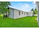 Exterior shot of a home with a large green backyard and grill at 405 S 7Th Ave, Bartow, FL 33830