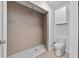 This bathroom has a tiled shower with modern showerhead and a modern toilet at 405 S 7Th Ave, Bartow, FL 33830