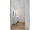 Bright bathroom with a modern vanity, stylish light fixture, and wood-look flooring at 405 S 7Th Ave, Bartow, FL 33830