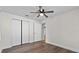 This bedroom has wood-look floors, a ceiling fan and a double-door closet at 405 S 7Th Ave, Bartow, FL 33830