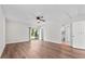 This bedroom has wood-look floors, access to the backyard, and doors to the bathroom and hallway at 405 S 7Th Ave, Bartow, FL 33830