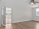 This bedroom offers a ceiling fan, wood-look floors and a view of the backyard at 405 S 7Th Ave, Bartow, FL 33830