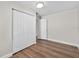 Bedroom featuring hardwood floors and a closet with white paneled doors at 405 S 7Th Ave, Bartow, FL 33830