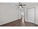 Bedroom with hardwood floors, a ceiling fan, closet and view to the kitchen at 405 S 7Th Ave, Bartow, FL 33830