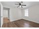 This bedroom has wood-look floors, a ceiling fan and a view of the front yard at 405 S 7Th Ave, Bartow, FL 33830