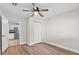 Bedroom with hardwood floors, a ceiling fan, closet and view to the kitchen at 405 S 7Th Ave, Bartow, FL 33830