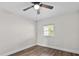 Bedroom featuring hardwood floors, a window, and a ceiling fan at 405 S 7Th Ave, Bartow, FL 33830