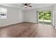 This bedroom offers a ceiling fan, wood-look floors and access to the yard through a sliding glass door at 405 S 7Th Ave, Bartow, FL 33830