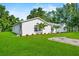 Charming single-story home with a well-manicured lawn and fresh landscaping on a beautiful sunny day at 405 S 7Th Ave, Bartow, FL 33830