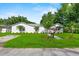 Quaint single-story home with a well-manicured lawn, fresh landscaping, and a classic mailbox on a beautiful sunny day at 405 S 7Th Ave, Bartow, FL 33830