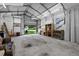 Large metal garage with roll up door, concrete floor, and plenty of workspace at 405 S 7Th Ave, Bartow, FL 33830