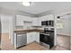 Bright kitchen features white cabinets, stainless steel dishwasher, and modern appliances at 405 S 7Th Ave, Bartow, FL 33830