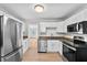 Well-lit kitchen with stainless steel appliances and granite countertops at 405 S 7Th Ave, Bartow, FL 33830