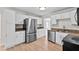 Well-lit kitchen with stainless steel appliances, granite countertops, and new flooring at 405 S 7Th Ave, Bartow, FL 33830