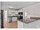 Kitchen showcasing stainless steel dishwasher and oven, granite countertops, and white cabinets at 405 S 7Th Ave, Bartow, FL 33830