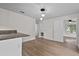The living room has updated light fixtures, wood flooring and bright natural light at 405 S 7Th Ave, Bartow, FL 33830