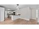 The living room features bright natural light, updated fixtures and wood flooring at 405 S 7Th Ave, Bartow, FL 33830