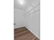 A walk-in closet with new-looking wood-look floors and a metal shelf at 405 S 7Th Ave, Bartow, FL 33830