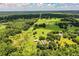 Expansive aerial view of a property featuring lush greenery and scattered homes under a partly cloudy sky at 4510 Cindy Rd, Lakeland, FL 33810