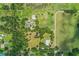 Large parcel of land featuring a home, pool, outbuildings, and sprawling green spaces, offering privacy and space at 4510 Cindy Rd, Lakeland, FL 33810