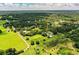 Expansive property featuring a home, pool, and outbuildings amid lush greenery and mature trees at 4510 Cindy Rd, Lakeland, FL 33810