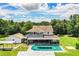 Spacious home features a large backyard, inground pool, carport, and ample green space surrounded by mature trees at 4510 Cindy Rd, Lakeland, FL 33810